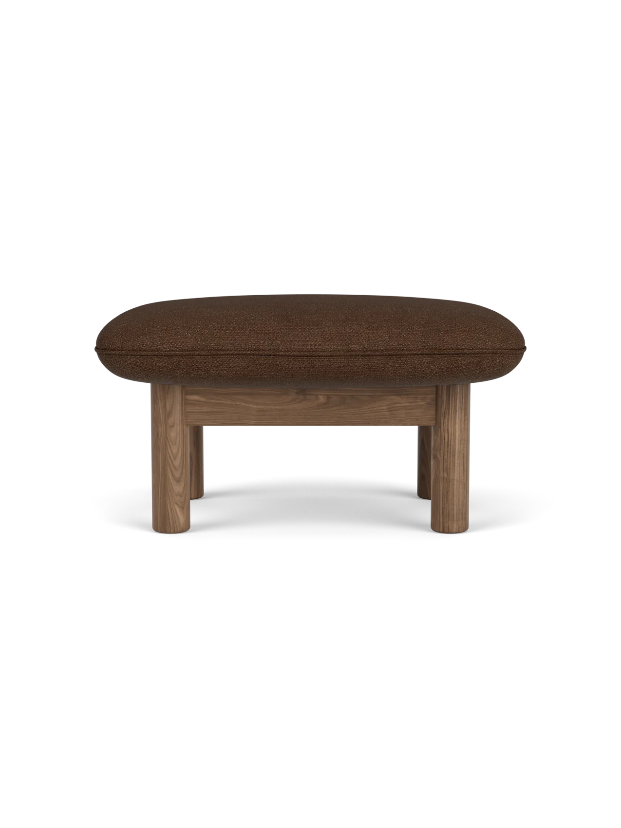 A side view of the Brasilia Ottoman with a walnut frame, four thick cylindrical legs and a plush cushion in brown bouclé.