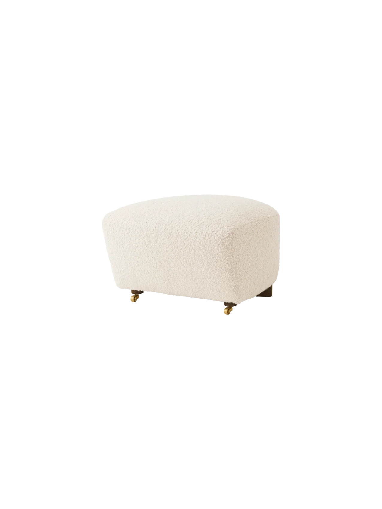 The Tired Man Ottoman in cream bouclé fabric, shown at an angle. It has dark wood legs with two brass casters at the front.