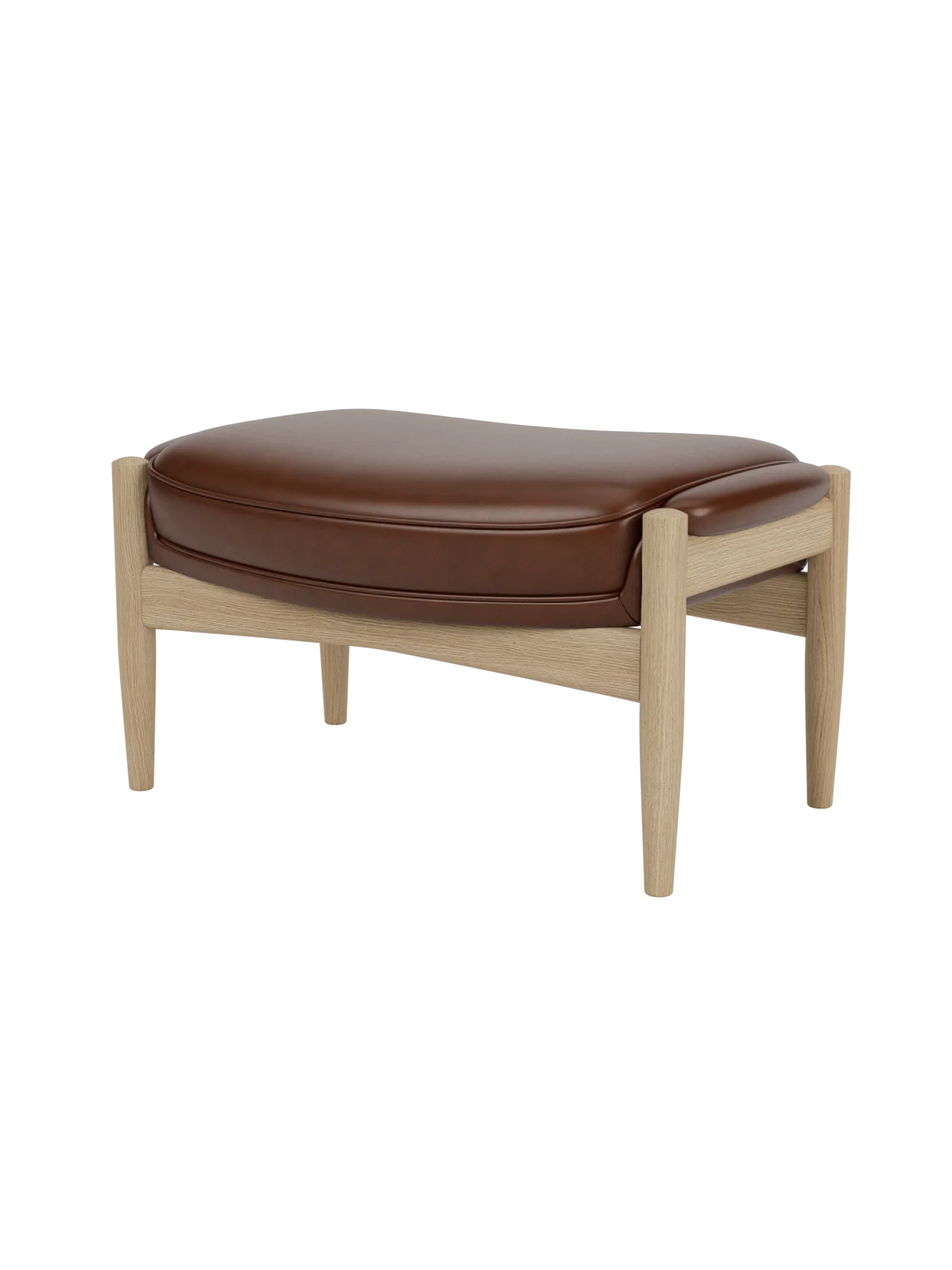 A side-profile view of The Seal Ottoman, showing its plush brown leather cushion and natural oak frame with tapered legs.
