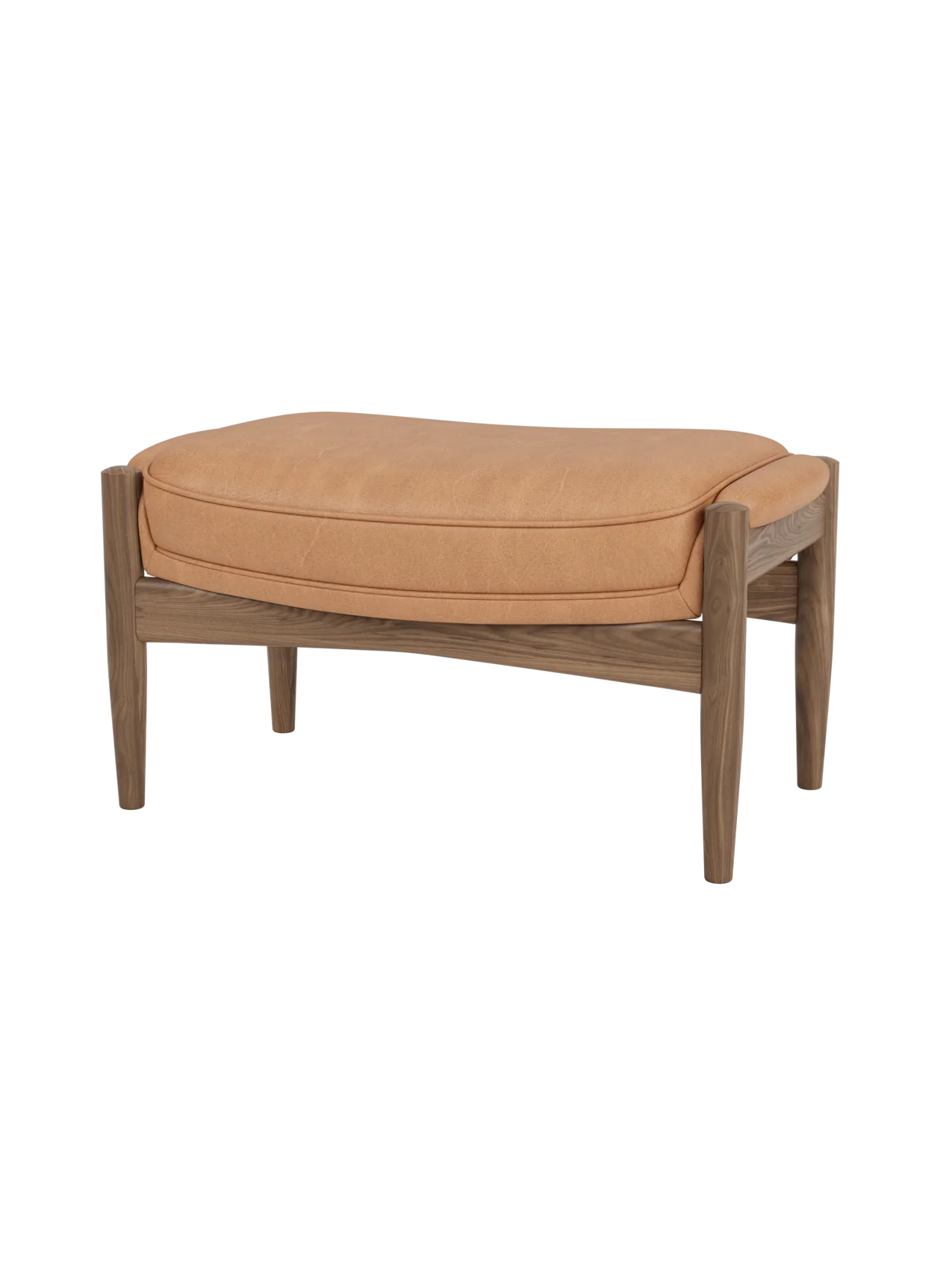 The Seal Ottoman in walnut wood with Dunes Camel leather upholstery, highlighting its organic mid-century silhouette.