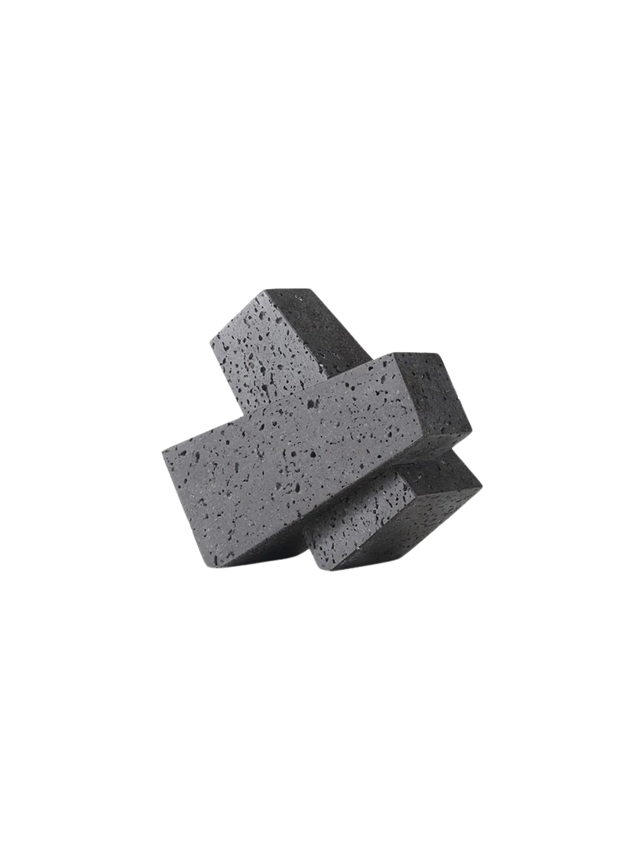 A dark grey, porous stone Converge Book End with an interlocking, geometric shape, shown at an angle on a black background.