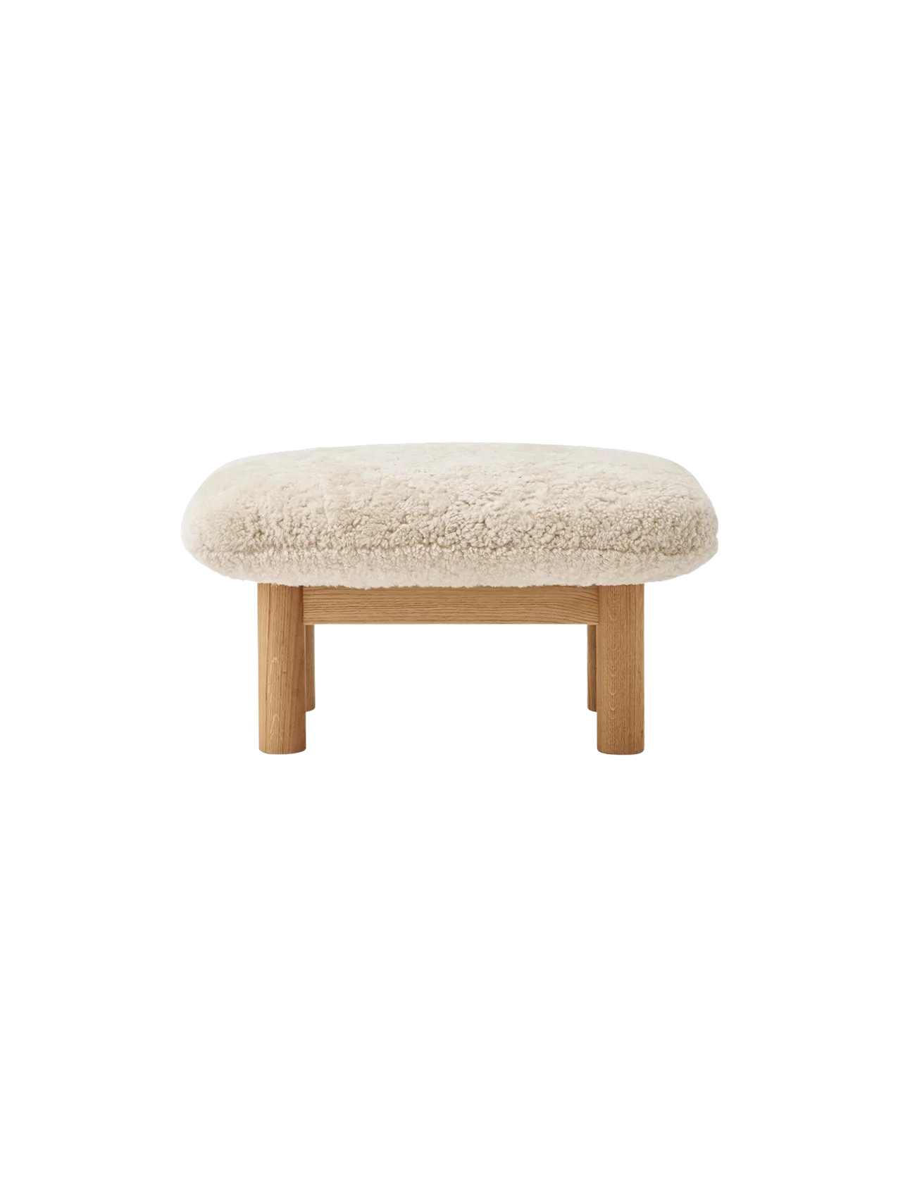 Front view of the Brasilia Lounge Ottoman, featuring a fluffy, off-white Sheepskin Nature cushion on a natural oak frame.