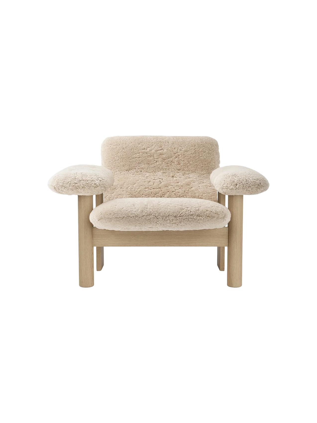 Front-on shot of the Brasilia Lounge Chair, Low Back. It has a light oak frame and is upholstered in fluffy, beige sheepskin.