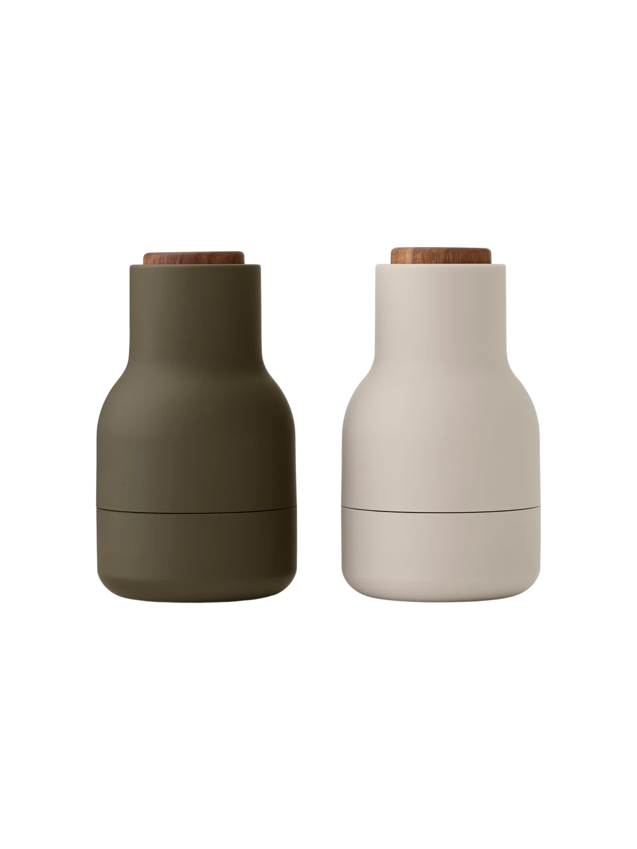 Bottle Grinders with walnut lids, one in matte hunting green and the other in matte beige, against a black background.