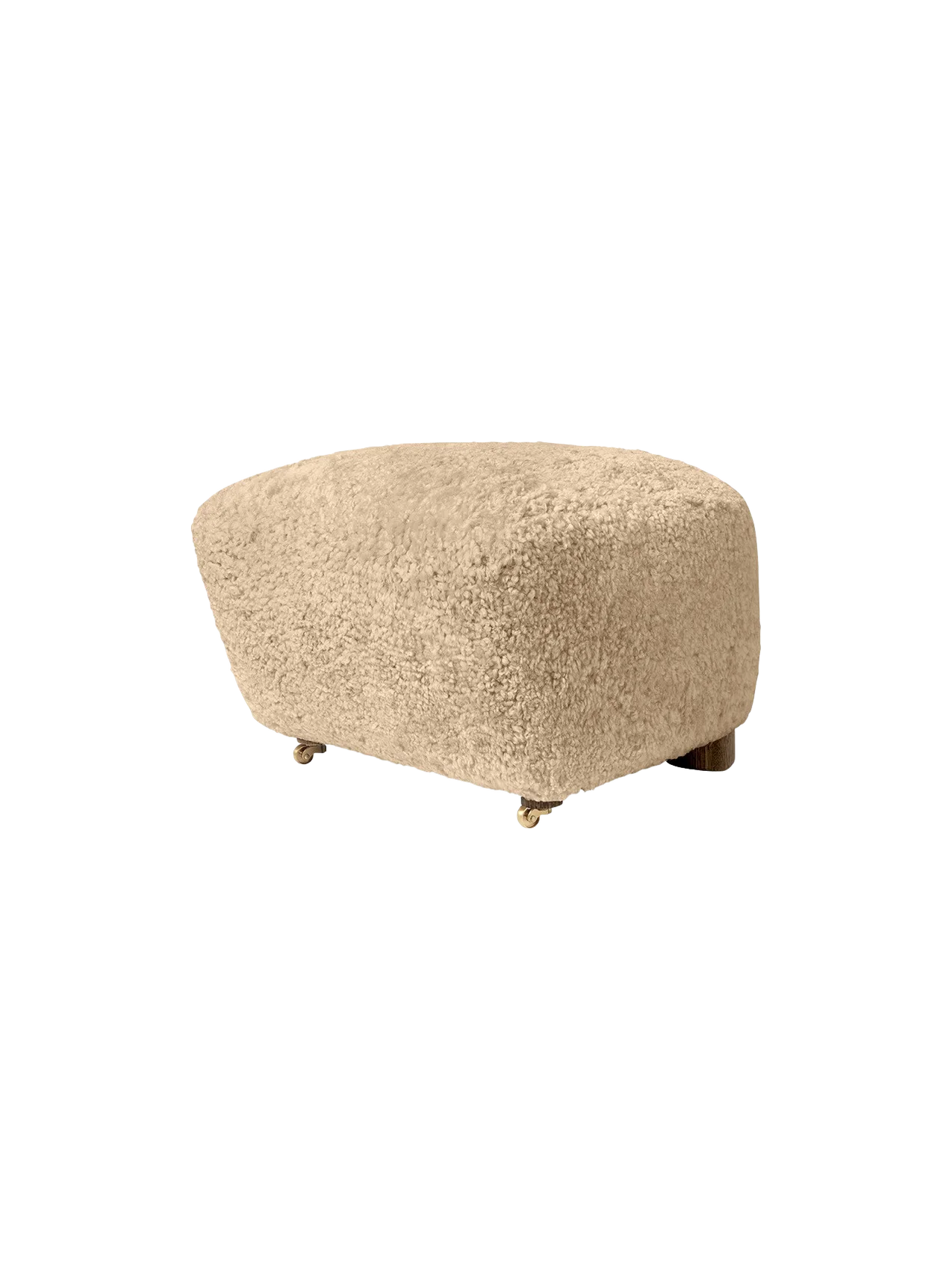 A side view of The Tired Man Ottoman upholstered in plush, honey-coloured sheepskin, set against a black background.