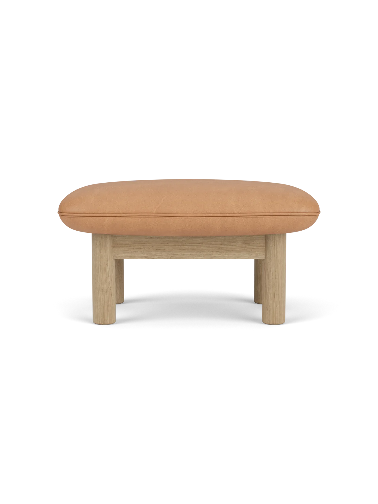 Side view of the Brasilia Ottoman with a camel leather cushion and a natural oak frame with four robust, cylindrical legs.