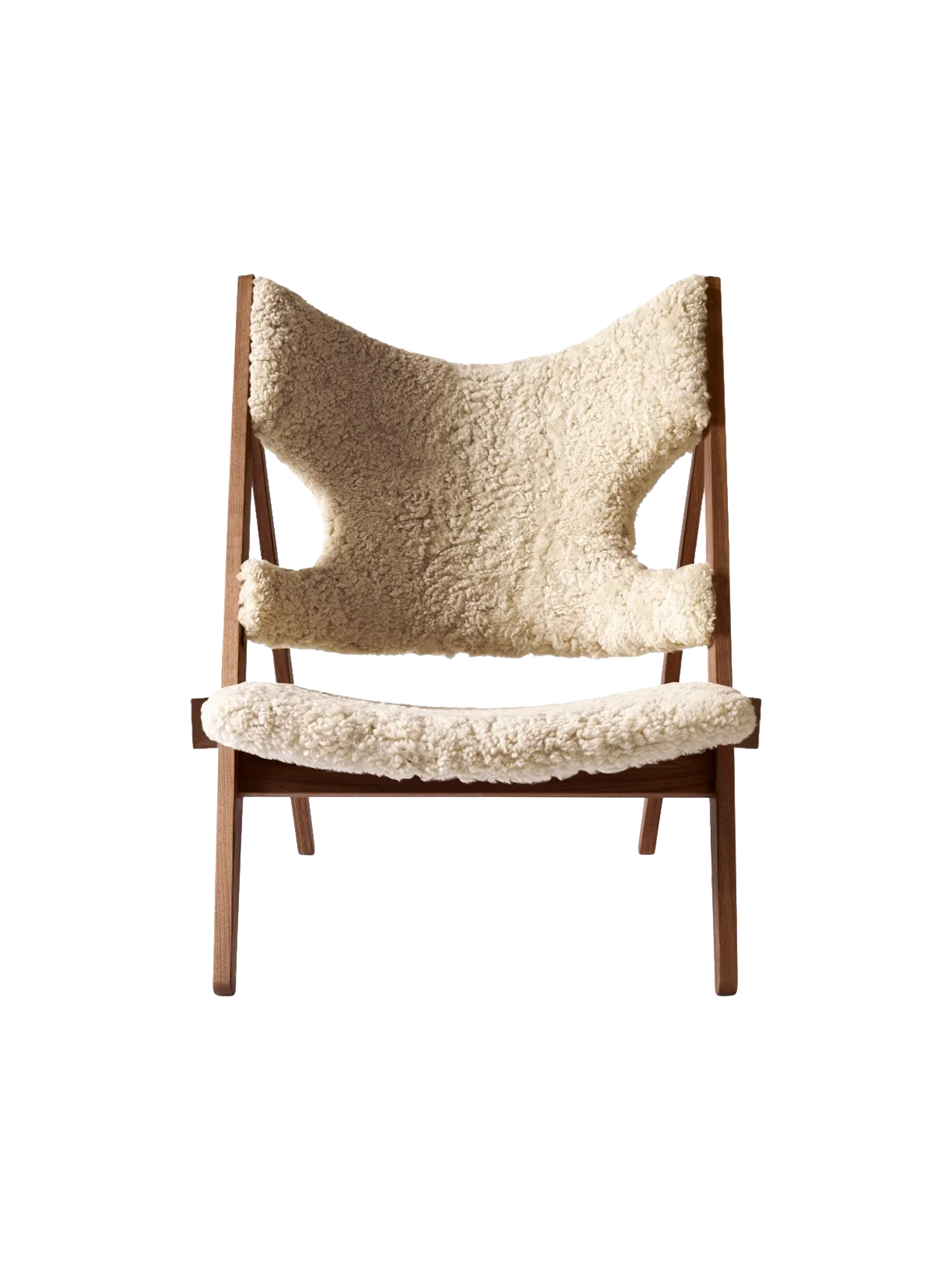 A front view of the Knitting Lounge Chair, featuring a dark walnut wood frame and upholstered in fluffy, natural sheepskin.