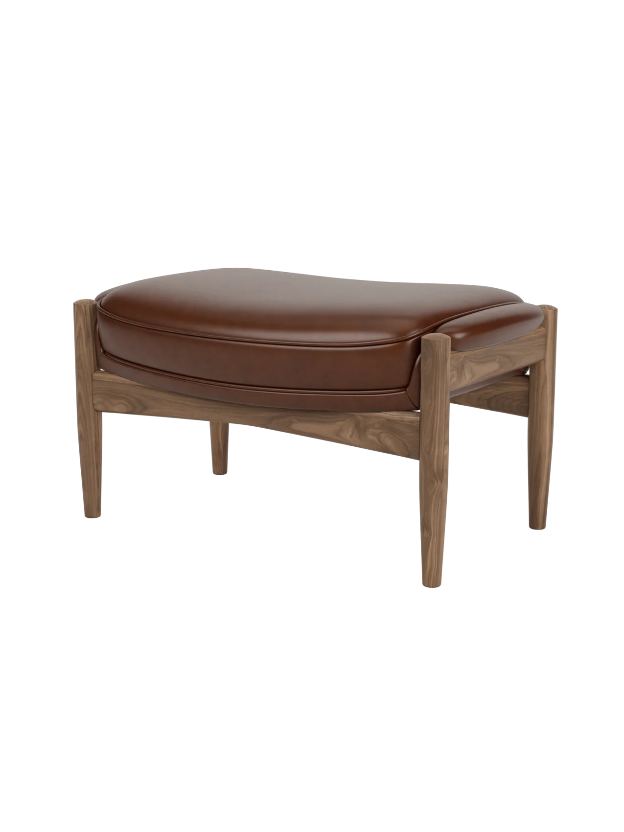 A three-quarter view of The Seal Ottoman, featuring a rich walnut wood frame and a plush, contoured brown leather cushion.