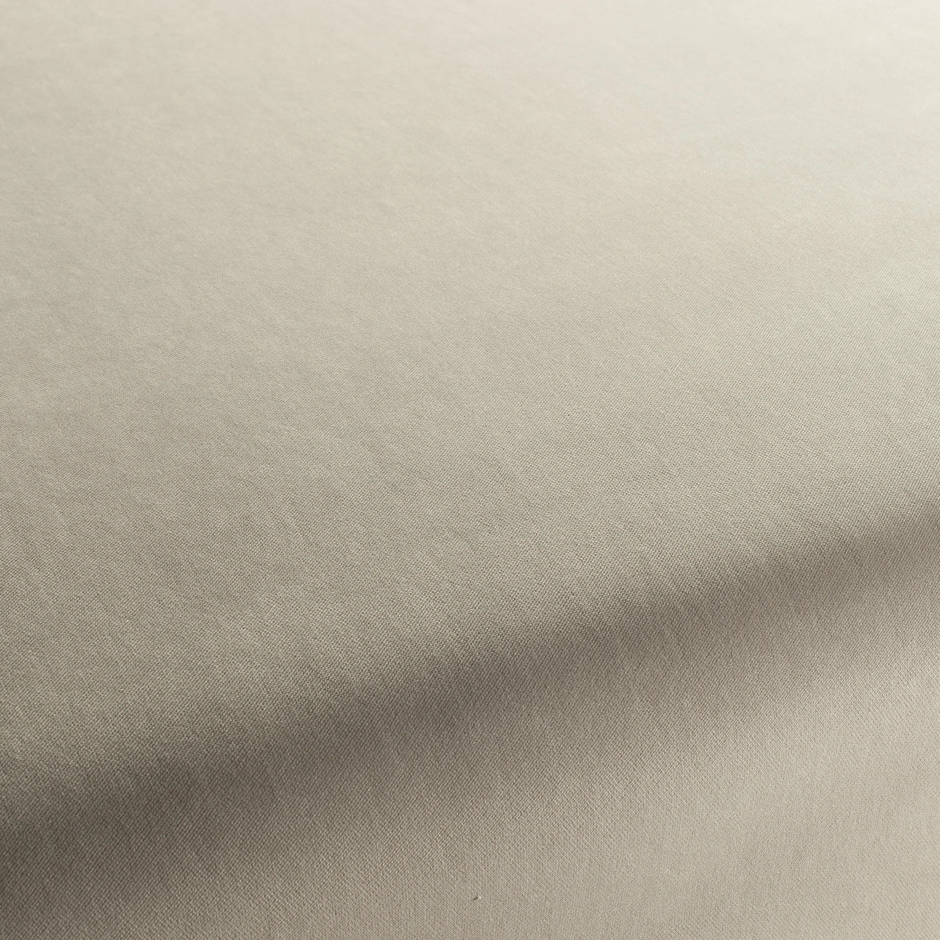 Close-up of light beige woven fabric with subtle texture and gentle folds