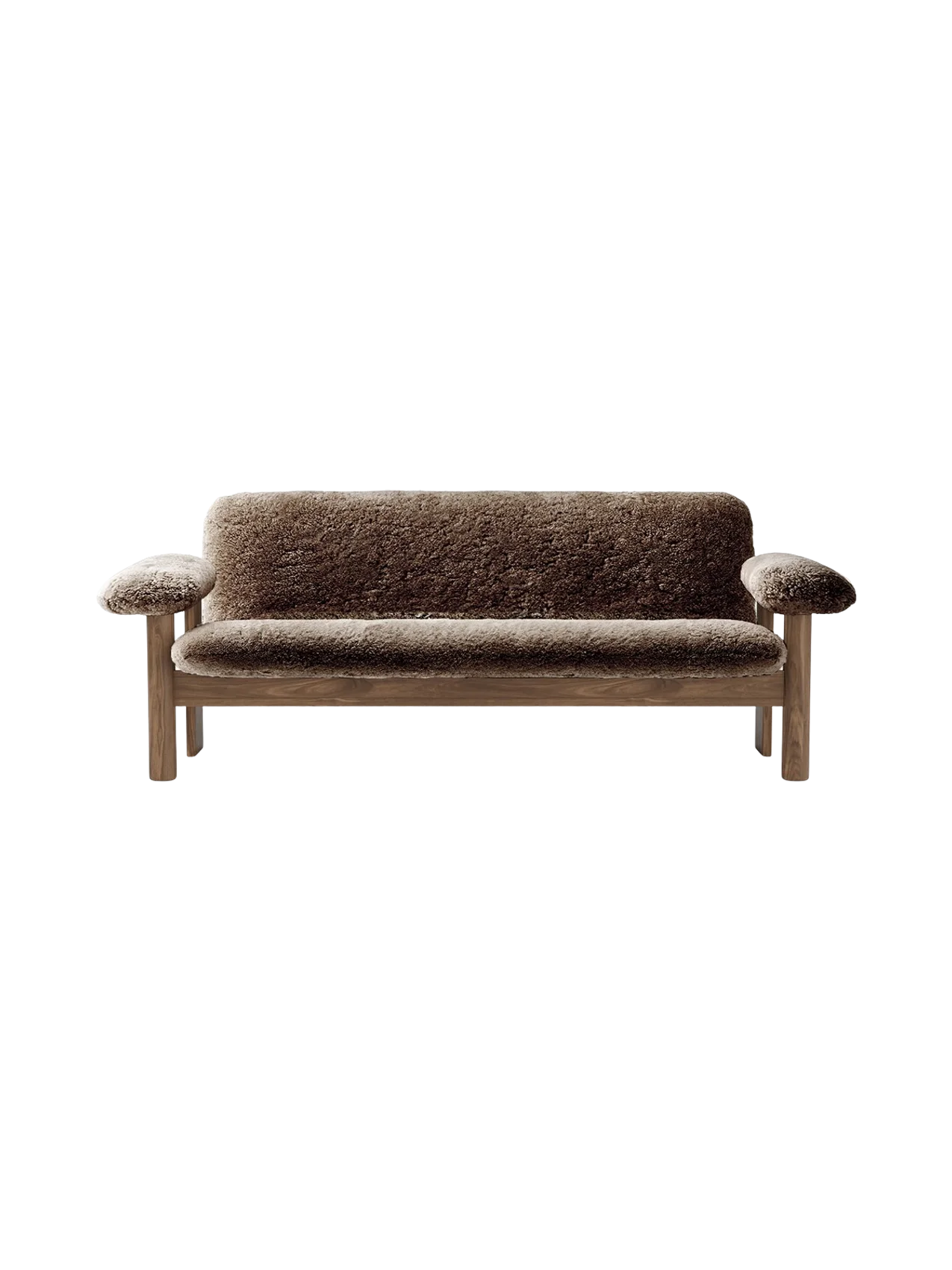 Front view of the Brasilia Sofa in plush brown sheepskin with a wooden frame and legs, against a black background.