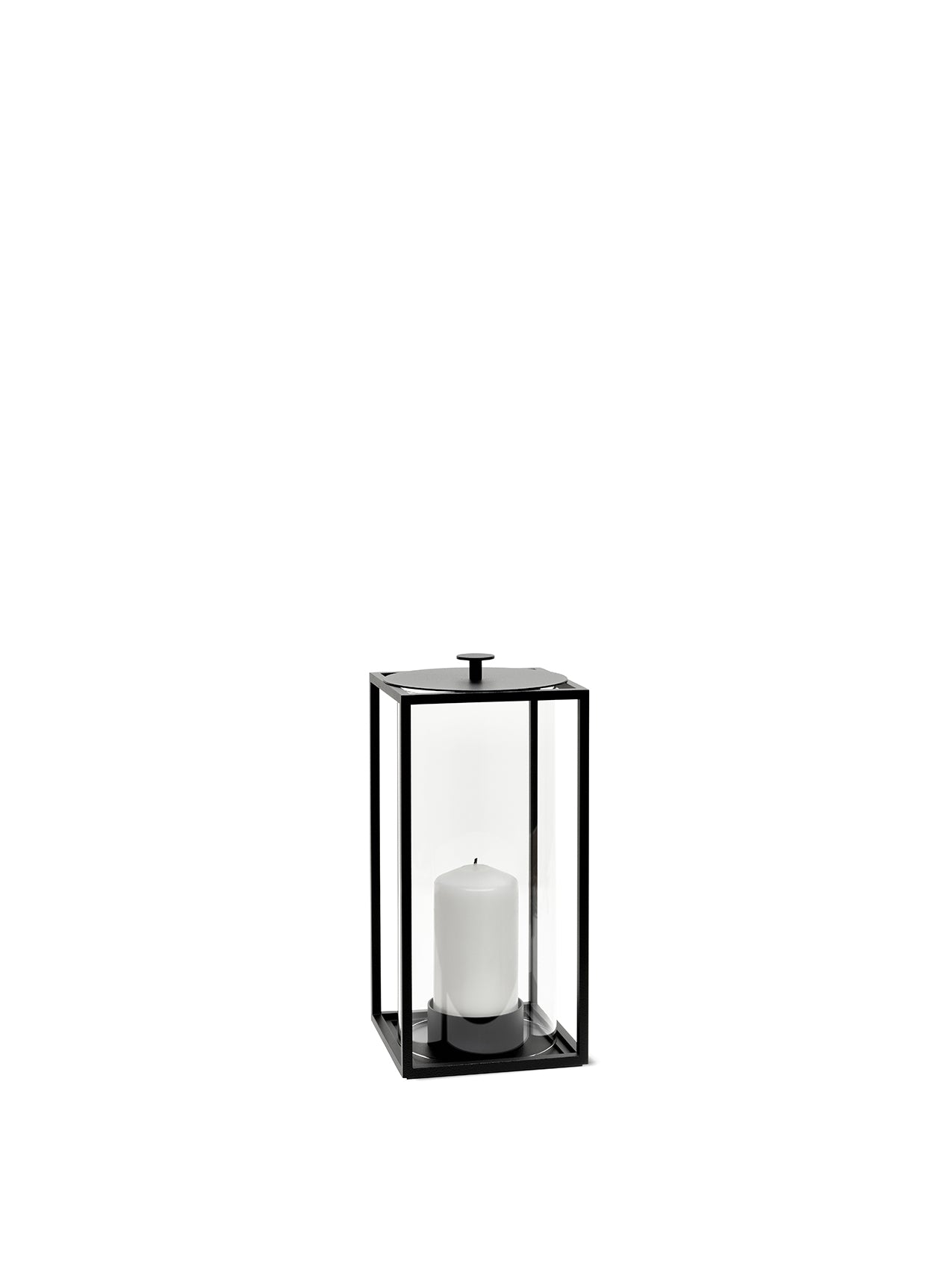The Light In Lantern, a medium-sized black metal and glass candle holder, shown with a white pillar candle inside.