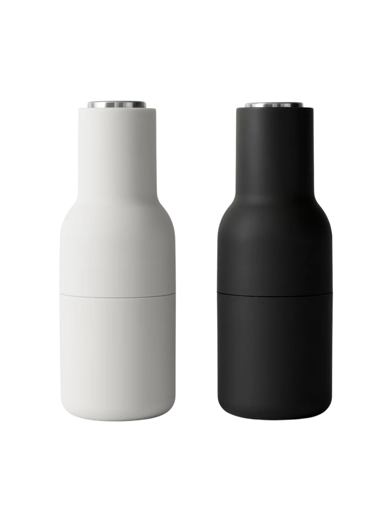 A pair of minimalist Bottle Grinders from Audo CPH, one in matte Ash and one in matte Carbon, both with brushed steel lids.