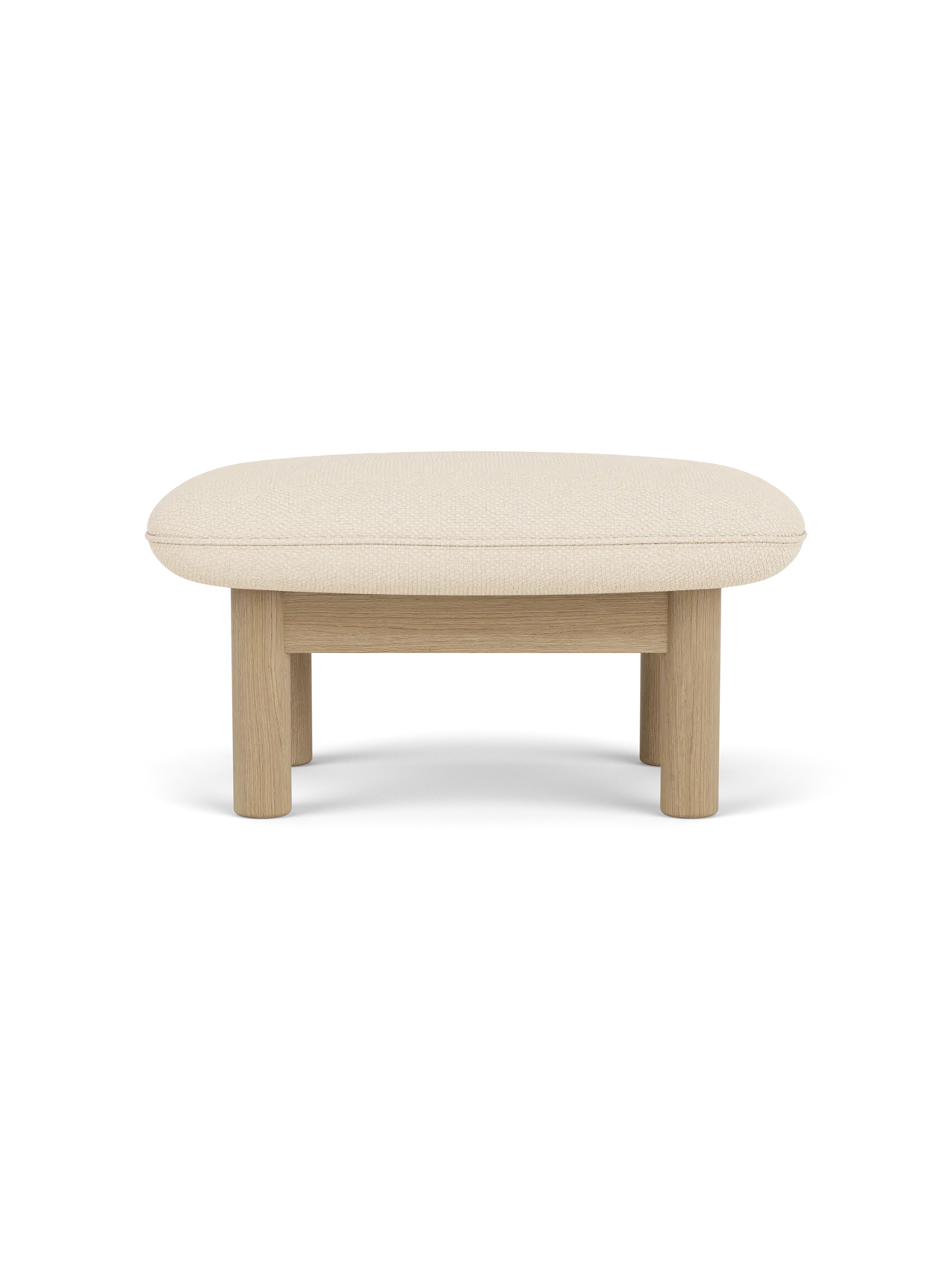 A side view of the Brasilia Ottoman with a natural oak frame and a light beige Logan Jasmine cushion on a black background.