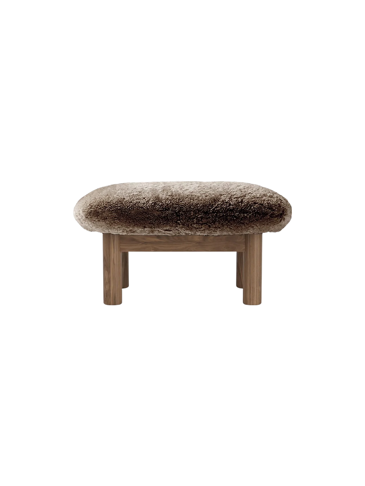 Brasilia Ottoman in Sheepskin, seen from the back. A thick, brown sheepskin seat on a wooden frame with four legs.