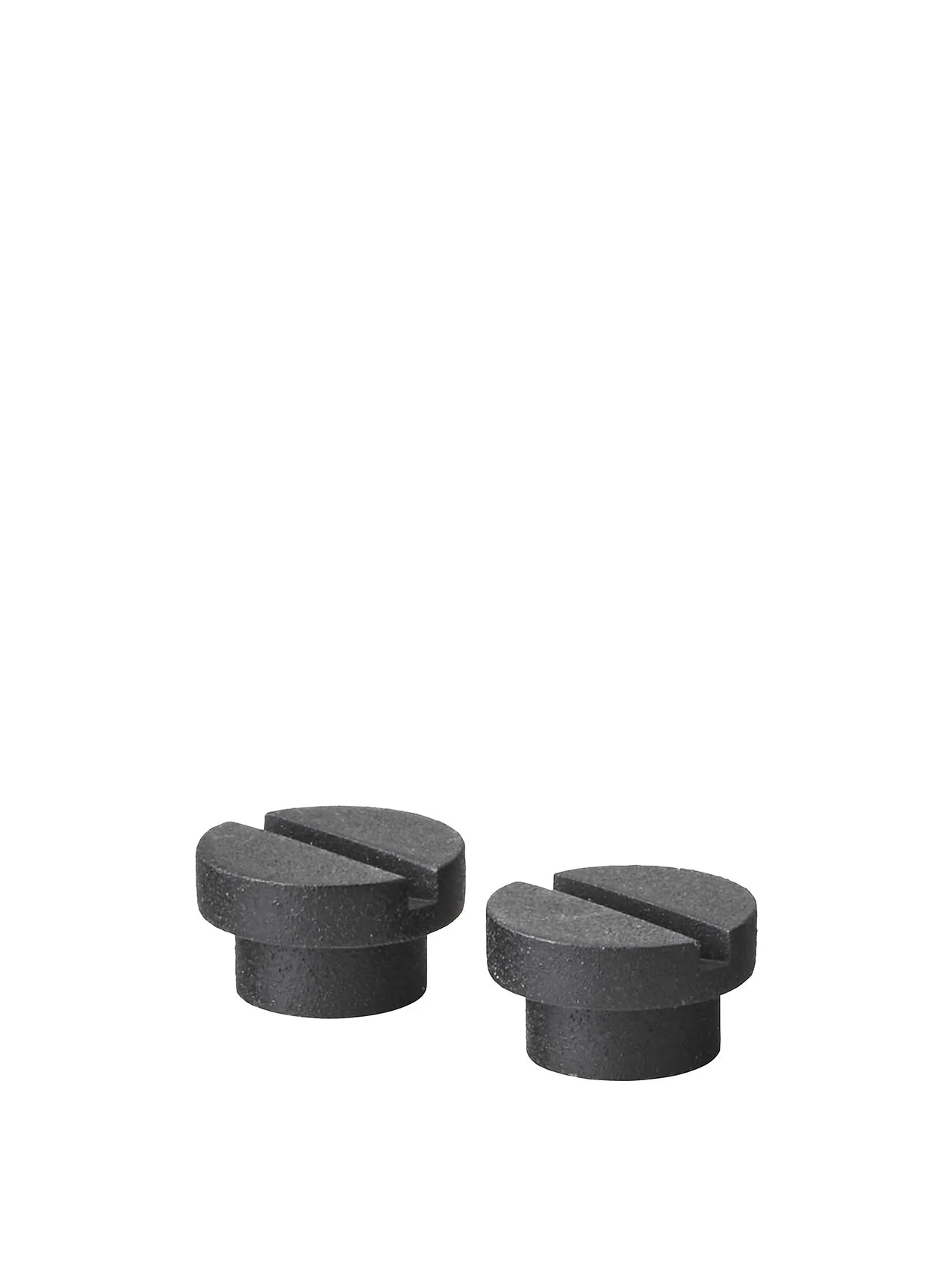 A close-up image of two small, black, textured plastic knobs with flat, slotted tops, set against a plain white background.