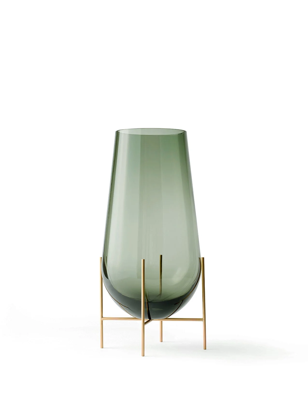 The small Echasse Vase, a smokey green glass vessel held in a slender, four-legged brass stand on a white background.