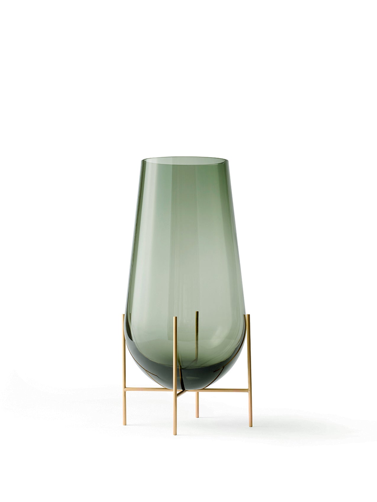 The small Echasse Vase, a smokey green glass vessel held in a slender, four-legged brass stand on a white background.