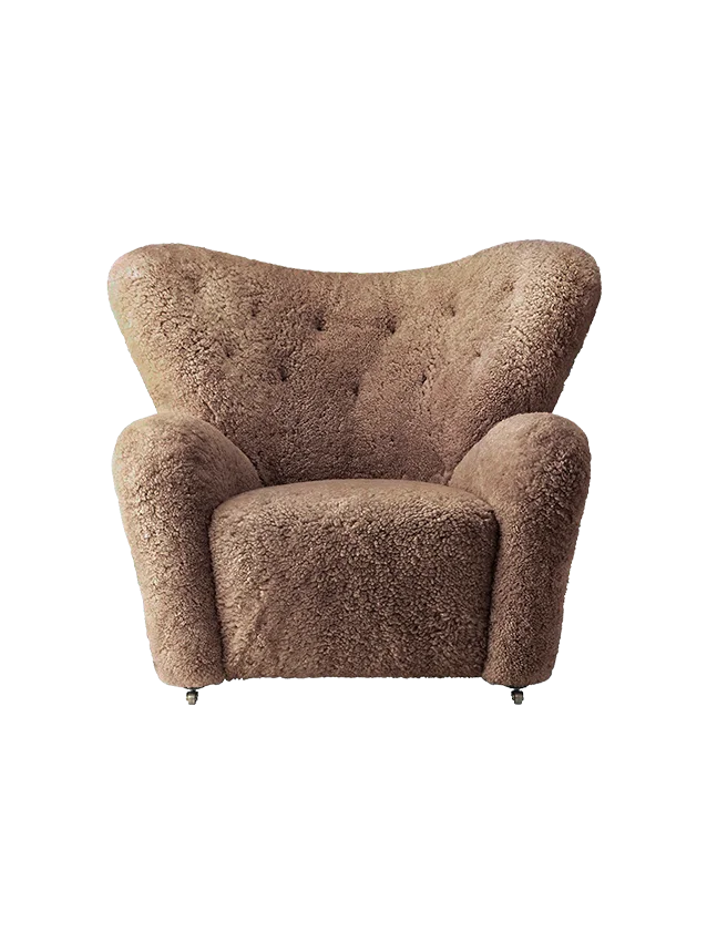 Front view of The Tired Man Lounge Chair in Sahara sheepskin, with a high back, button tufting and plush arms.