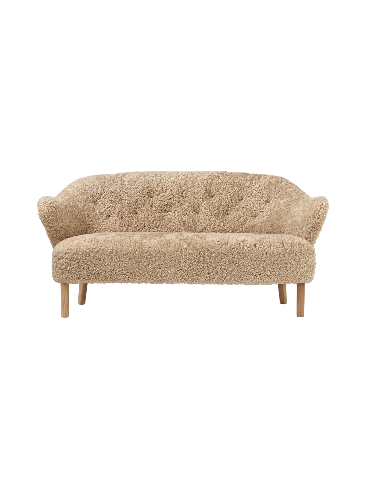 A front view of the Ingeborg Sofa, upholstered in textured honey sheepskin. It has a buttoned back and natural oak legs.
