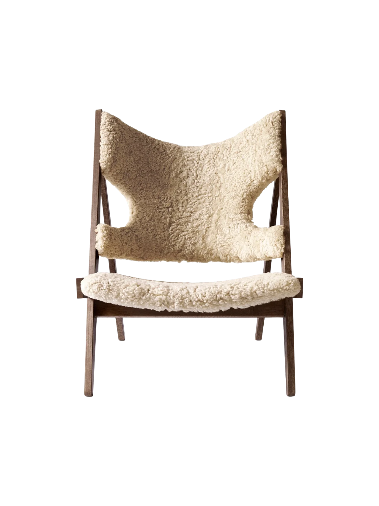 Front view of the Knitting Lounge Chair in natural sheepskin, with a dark stained oak frame against a black background.