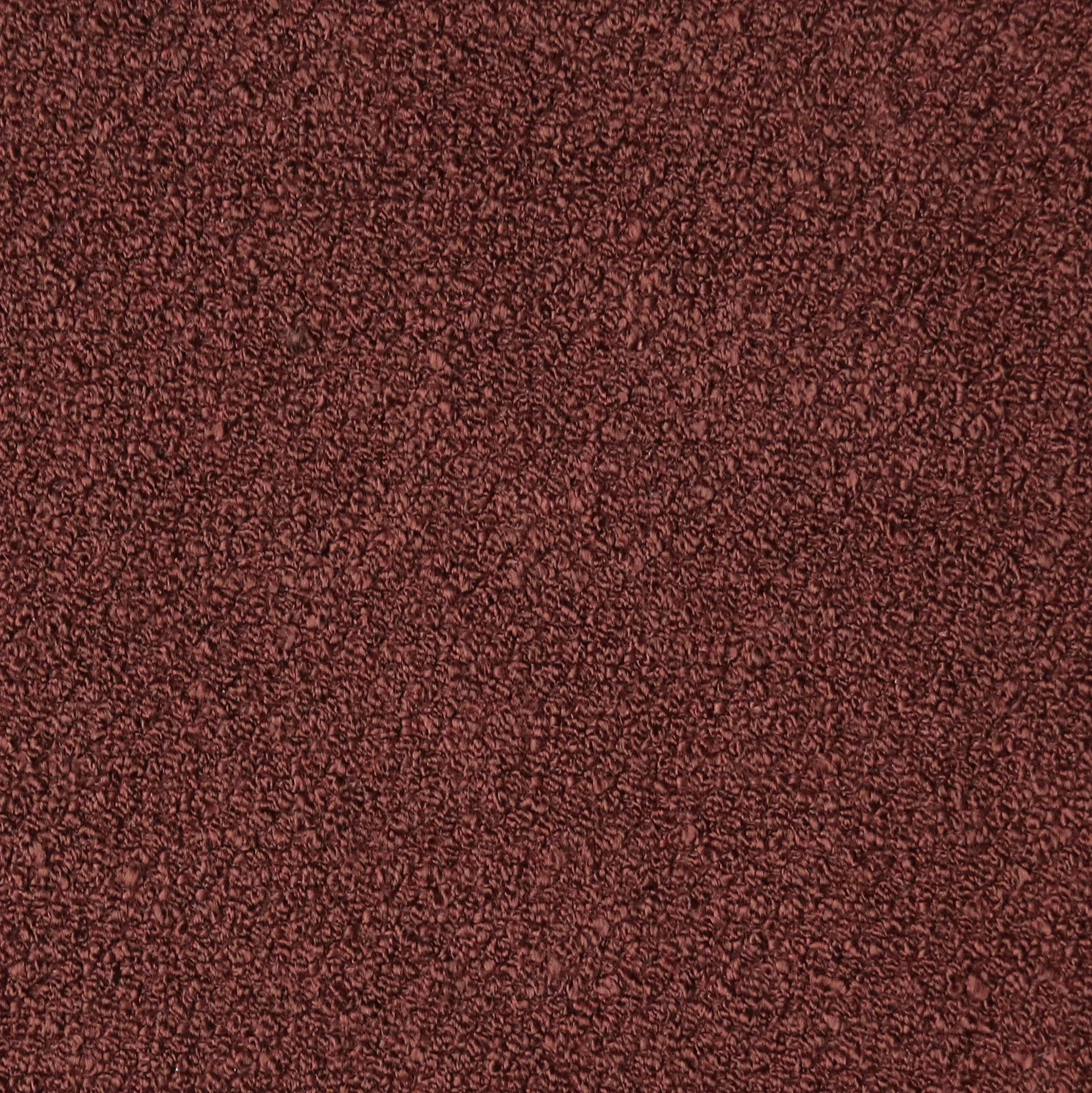 Close-up of deep burgundy boucle fabric with dense, looped wool texture