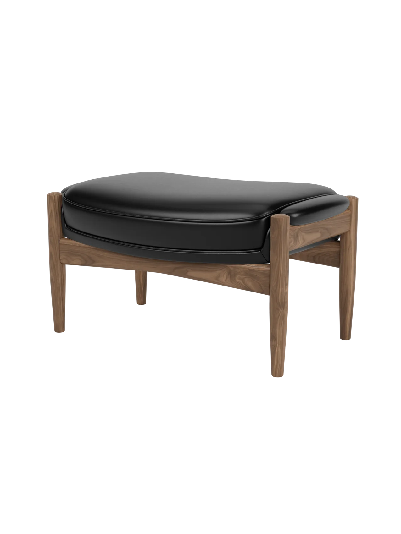A three-quarter view of The Seal Ottoman, featuring a solid walnut frame with curved supports and a padded black leather top.