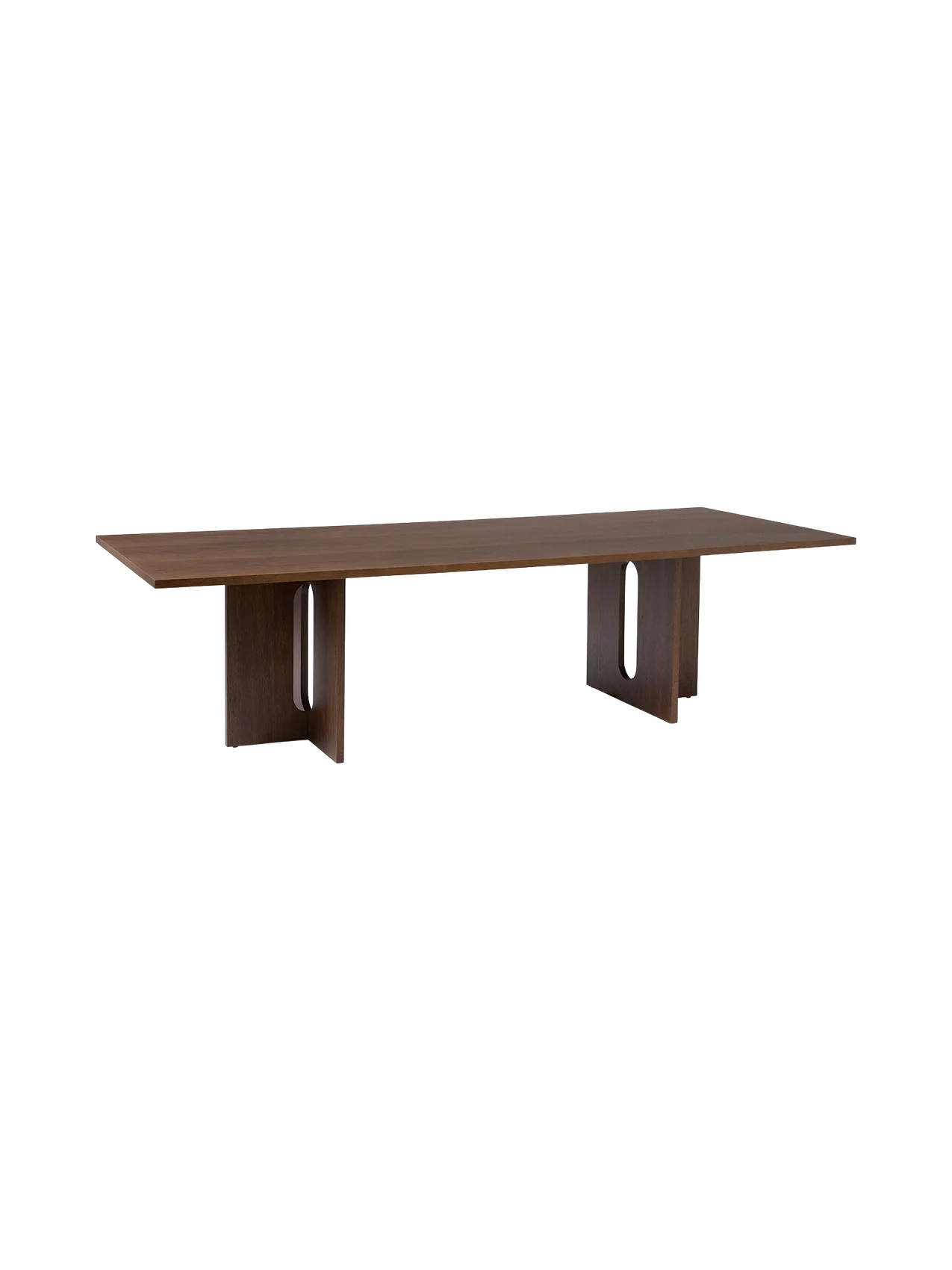 Angled view of the rectangular Androgyne Dining Table in dark stained oak, showing sculptural legs with large oval cut-outs.