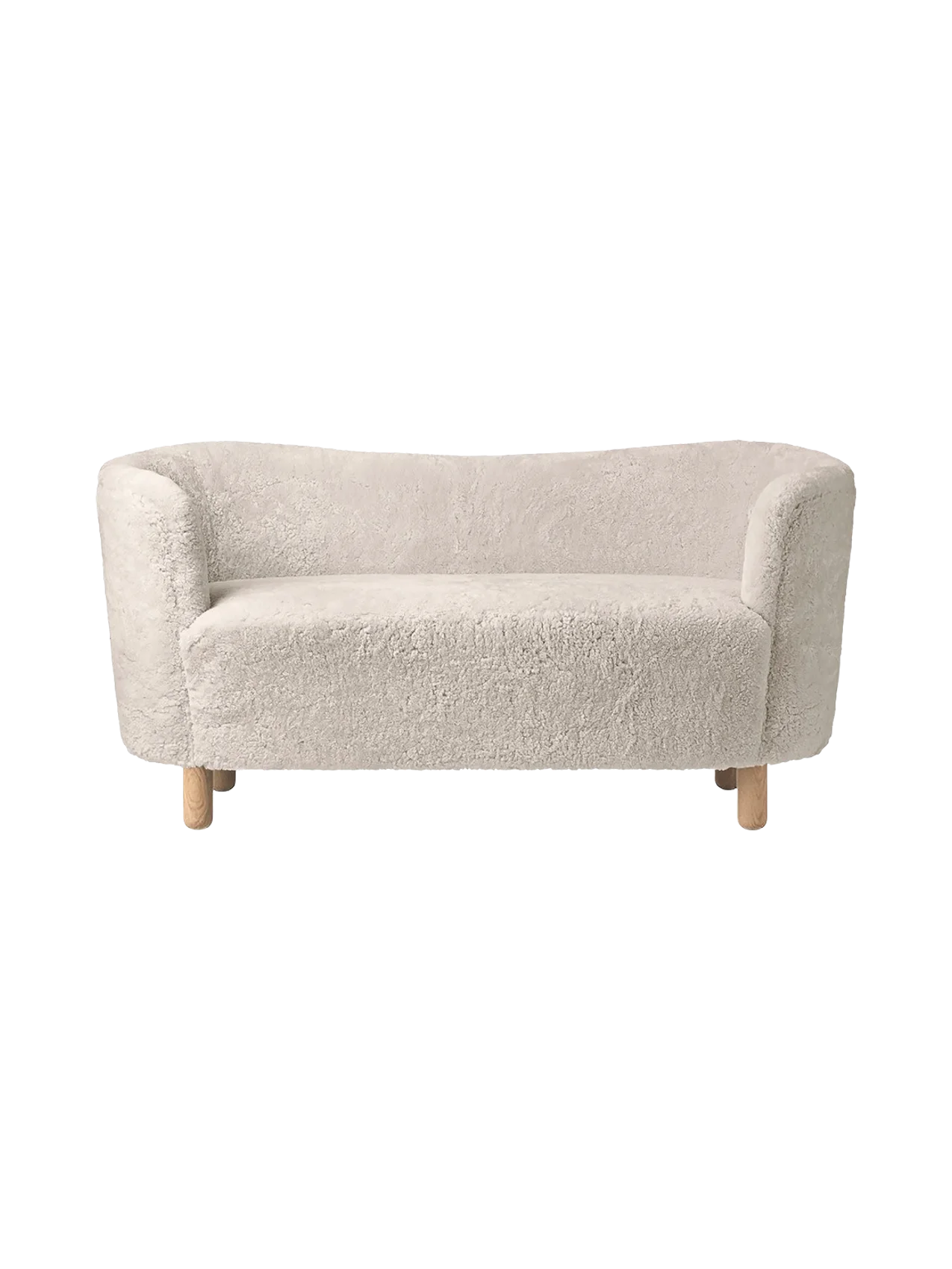A front view of the Mingle Sofa in off-white Moonlight sheepskin with a curved back, rounded arms, and natural oak legs.