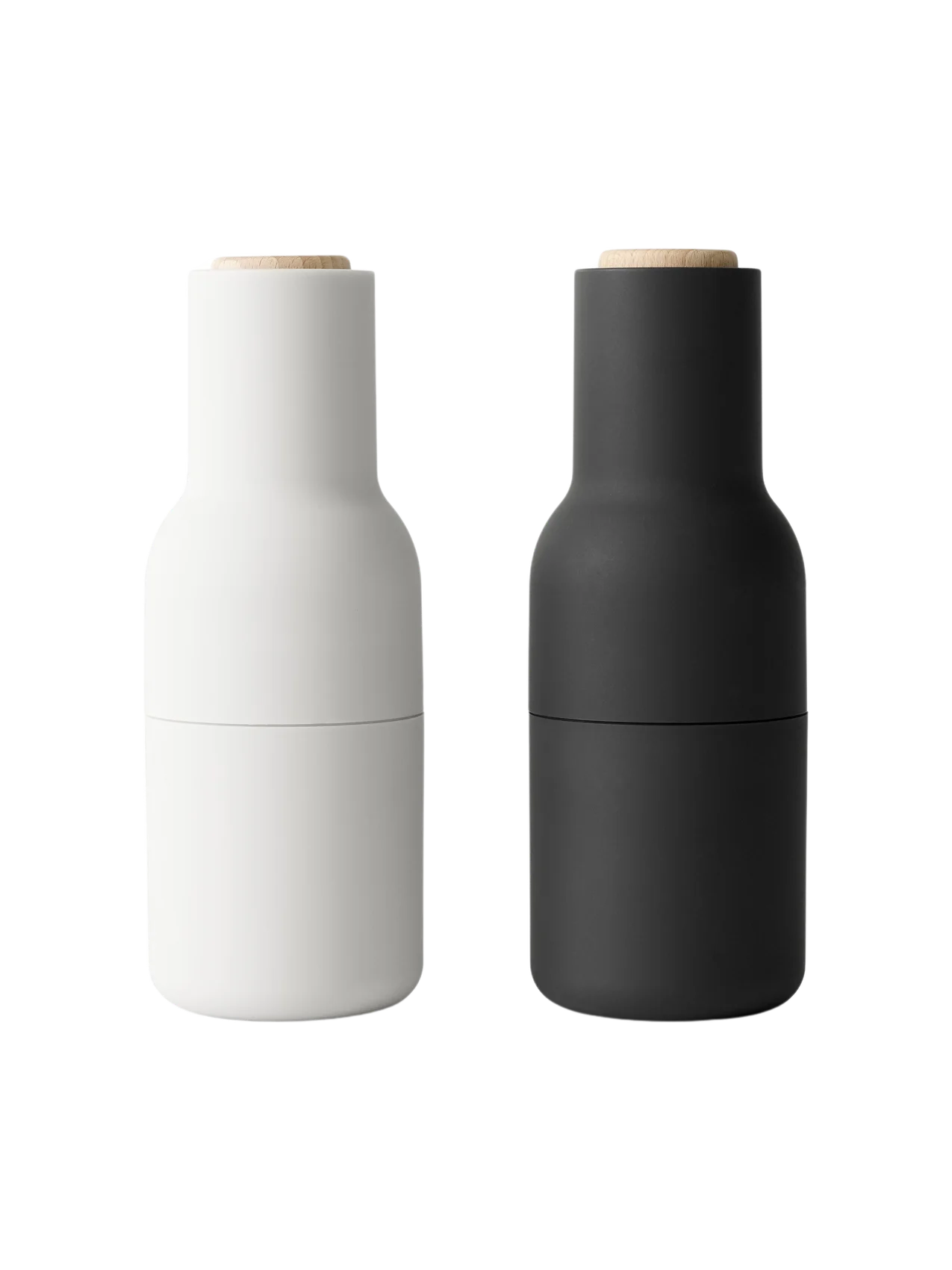 Two Bottle Grinders by Audo. The set includes one ash-coloured and one carbon-coloured grinder with a beech lid.