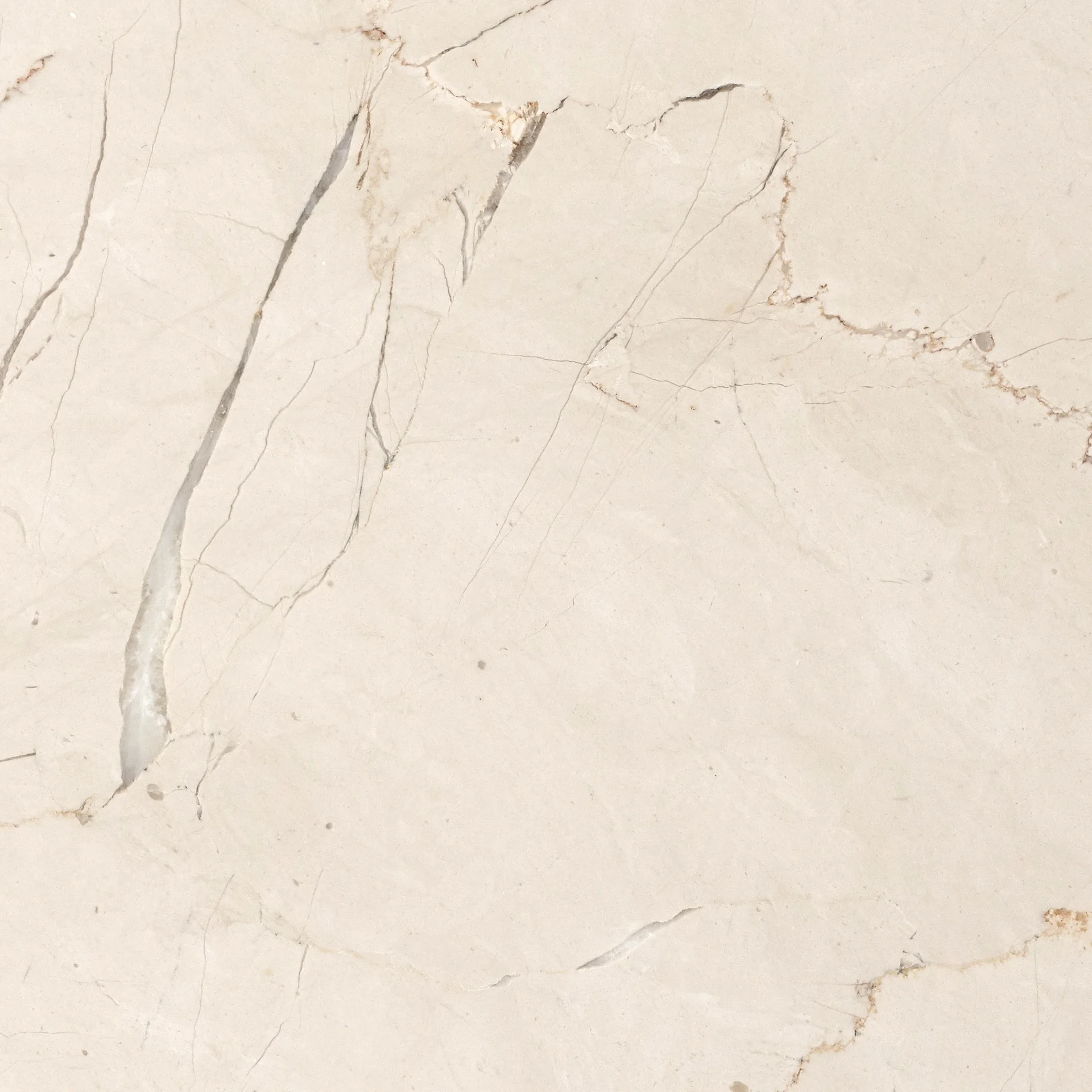 Close-up image of Crystal Rose Marble, featuring a creamy beige surface with intricate grey and brownish-red veins.
