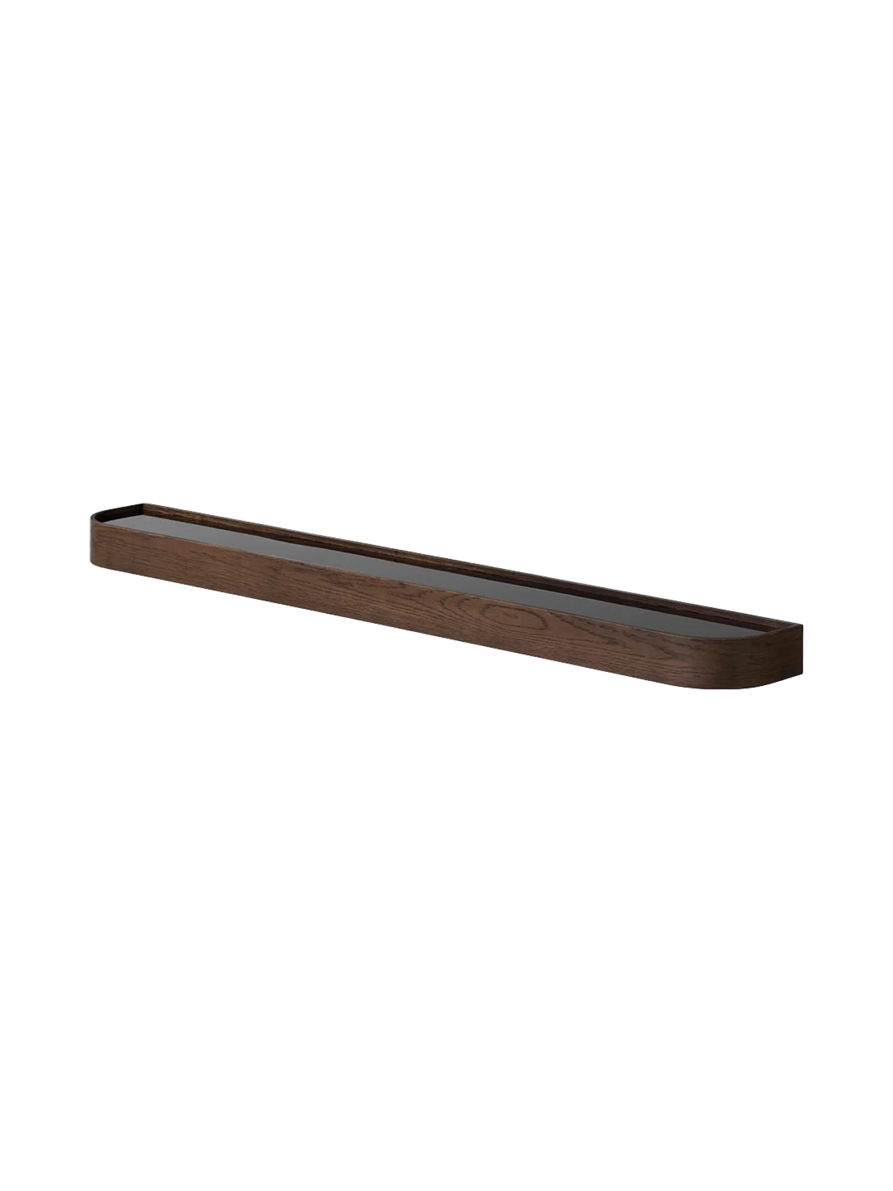 The Audo Échasse Tray, a long, minimalist tray in dark smoked oak with a glass base, shown at an angle.