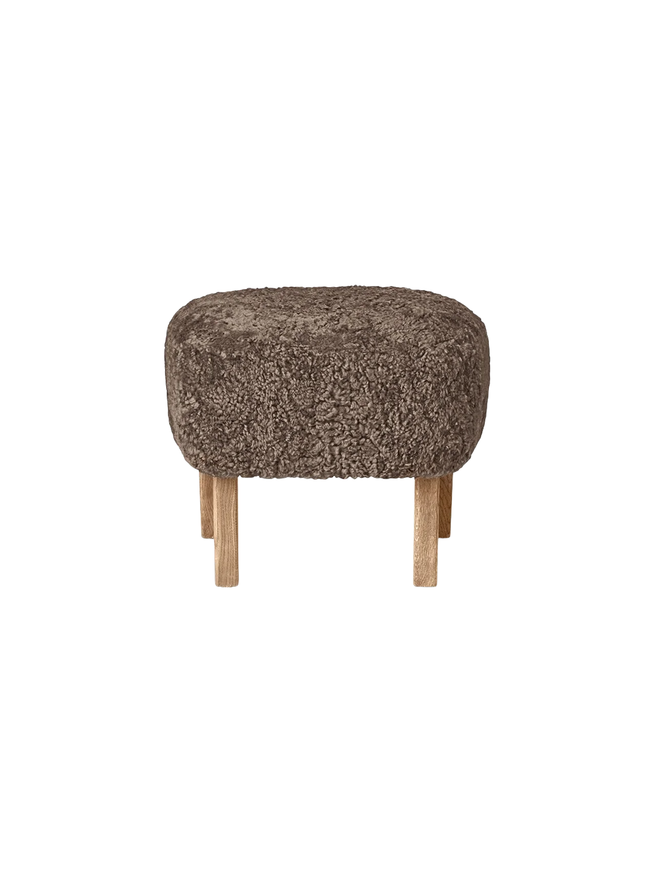 The oval Ingeborg Ottoman with a cushioned top upholstered in curly Sahara sheepskin on four short natural oak legs.
