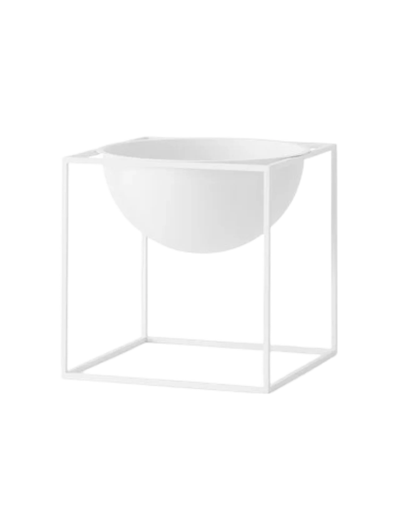 A large, white Kubus Bowl, held within a minimalist, cube-shaped metal frame, shown against a black background.