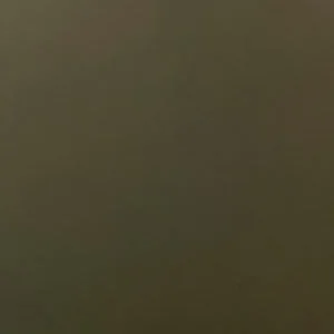 A close-up swatch of dark green glass, displaying a solid, deep green colour with a smooth, slightly matte finish.