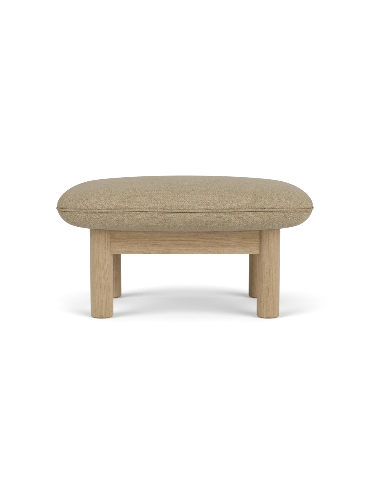 Side view of the Brasilia Ottoman with a light beige Audo Bouclé 02 cushion on a natural oak frame with thick, round legs.