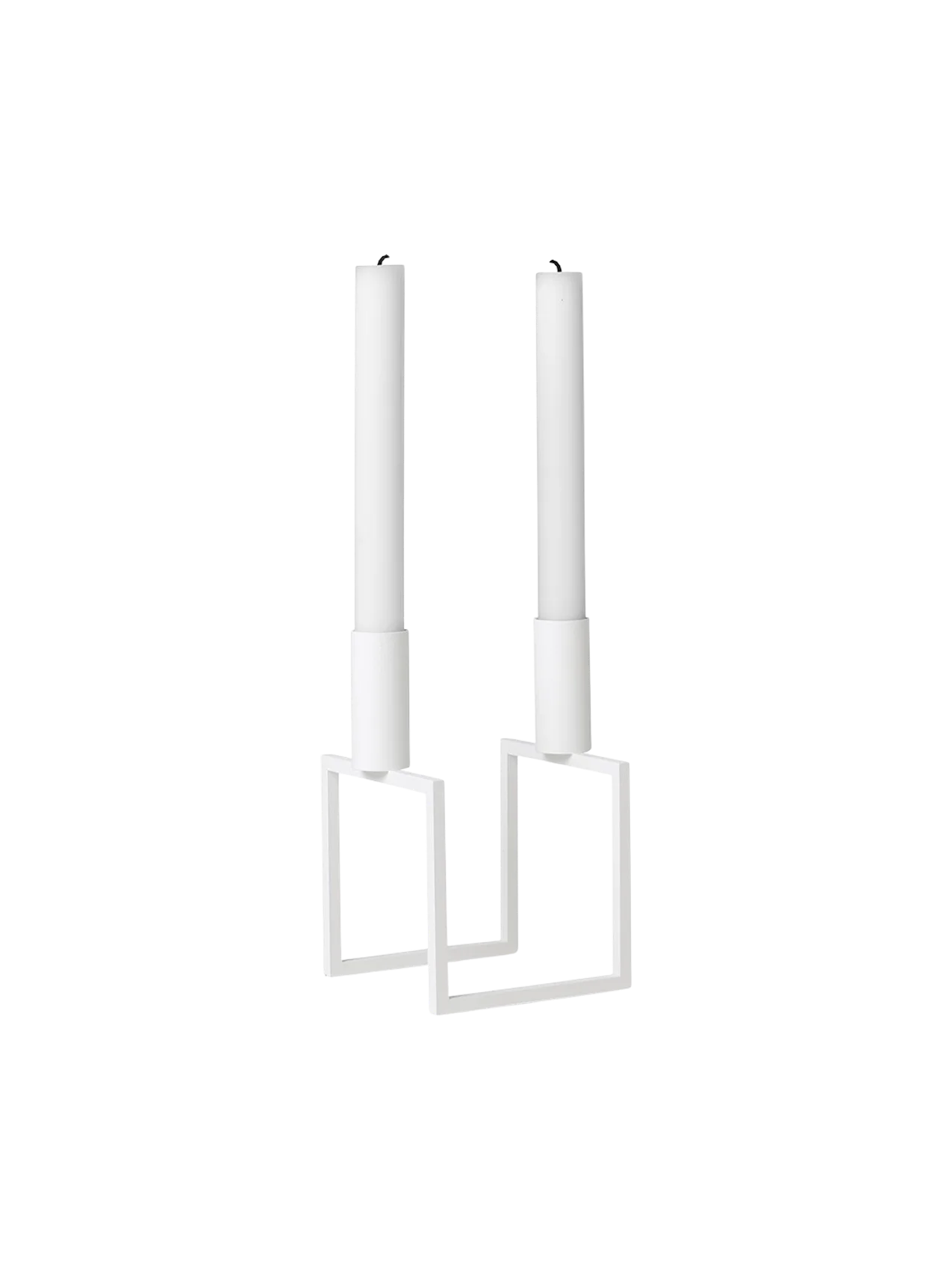 An angled view of the white Kubus Line candlestick, a minimalist design with a geometric frame, holding two white candles.