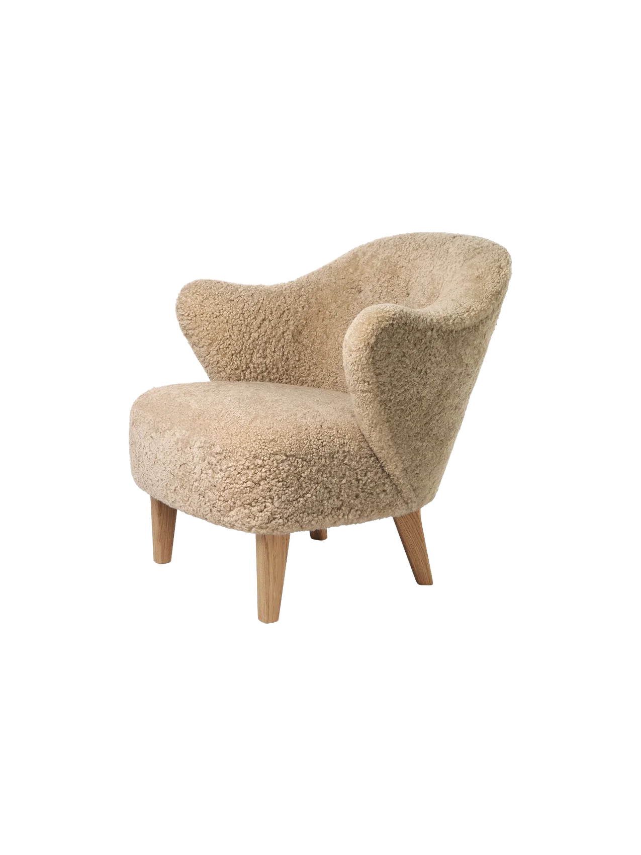 A studio shot of the Ingeborg Lounge Chair in honey sheepskin with curved armrests and light oak legs, from an angle.