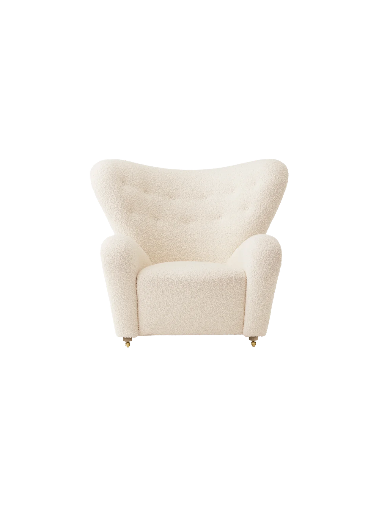 Front view of The Tired Man Lounge Chair in cream textile with a high, curved back, rounded arms and brass castors.