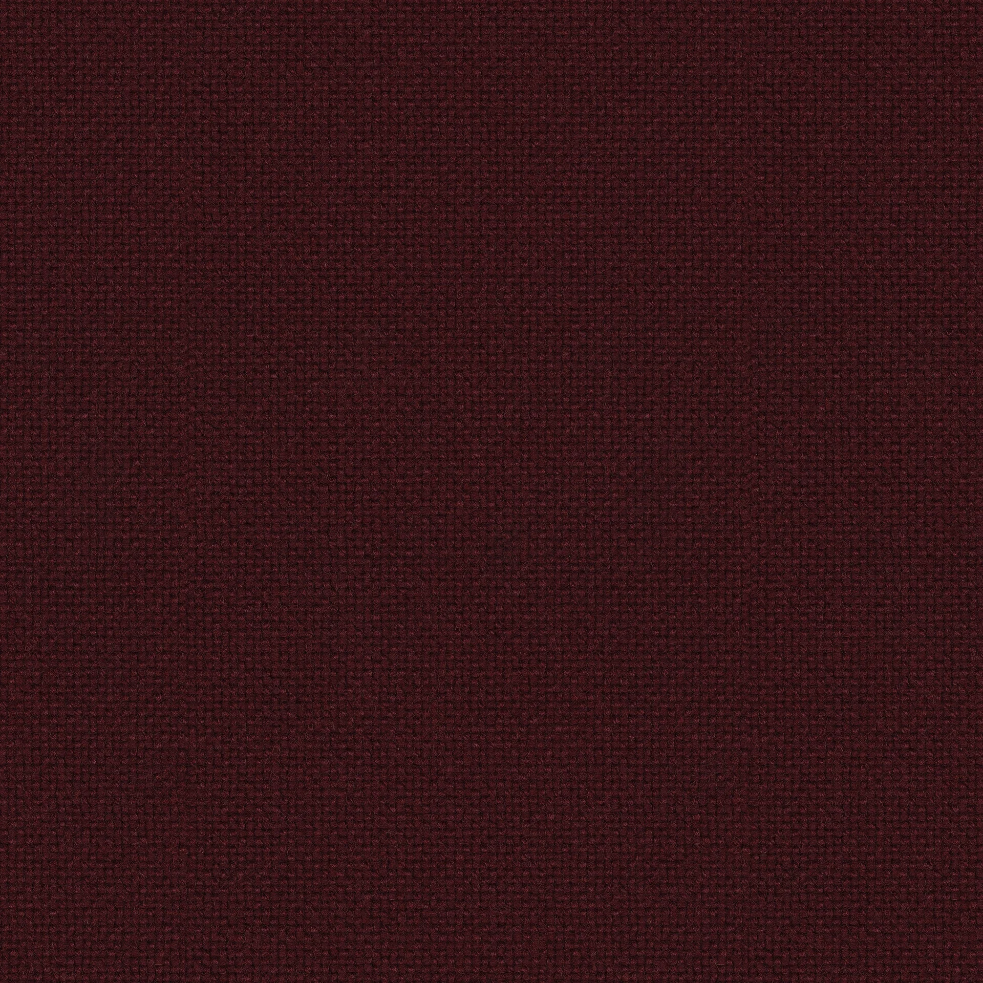 Close-up of deep burgundy woven wool fabric with visible looped texture and small square weave pattern