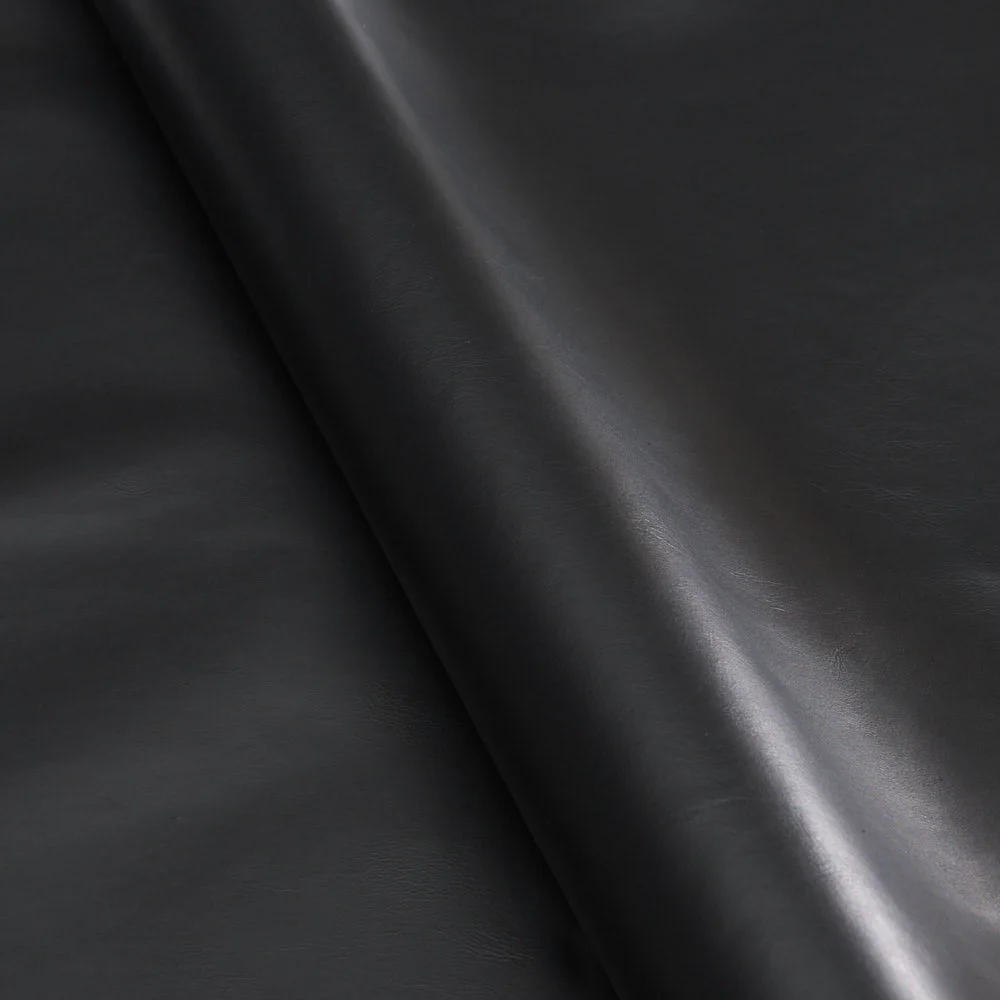Rolled black leather hide with smooth, slightly glossy surface and subtle natural grain