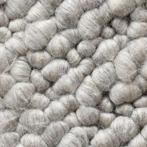 A close-up of the Gravel Grey fabric, showing the thick, nubby texture of its chunky, woven wool-like fibres.