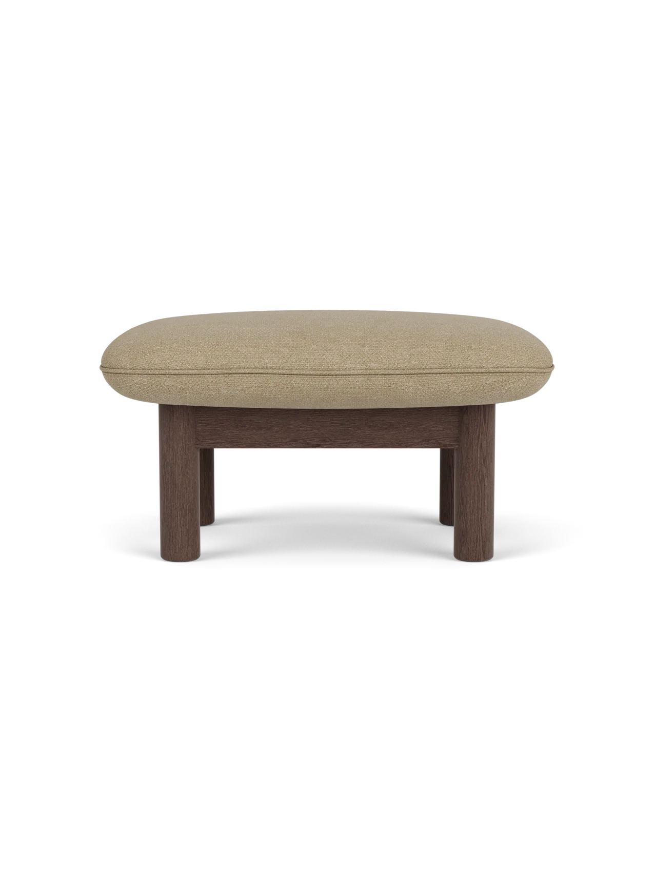Side view of the Brasilia Ottoman with a dark stained oak frame, robust cylindrical legs and soft Audo Bouclé 02 top.
