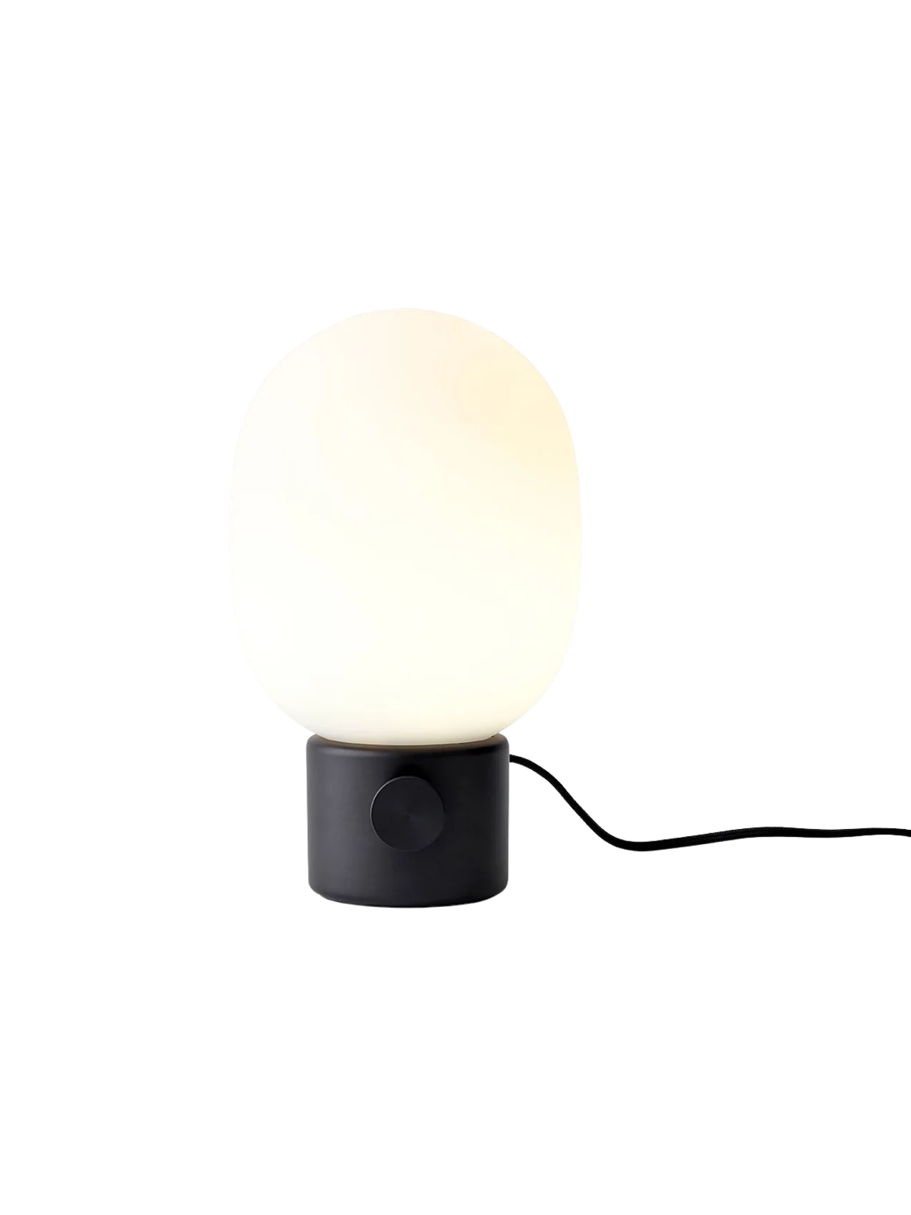 A front view of the JWDA Table Lamp, Small, in black painted steel with its illuminated white opal glass shade.