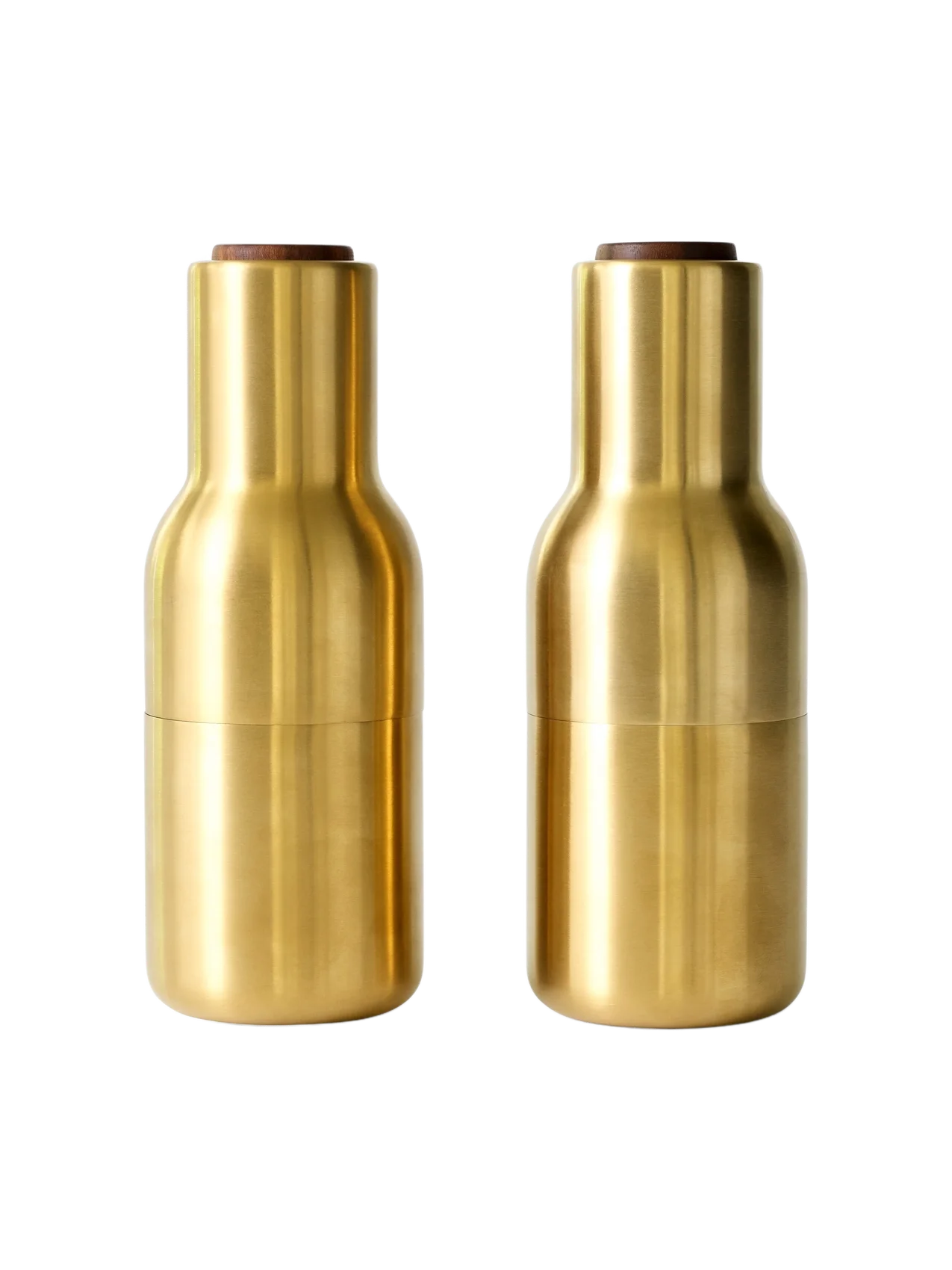 A pair of Bottle Grinders in brushed brass with walnut lids, presented side-by-side against a black background.