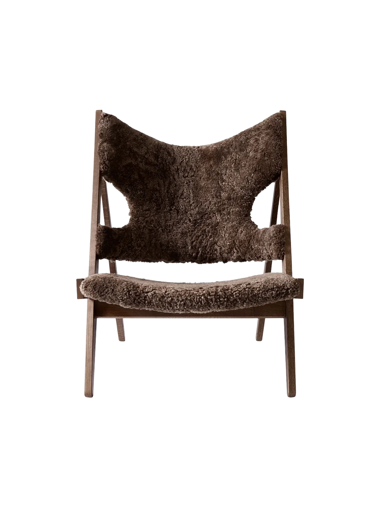 A front view of the Knitting Lounge Chair with a dark stained oak frame and plush, dark brown sheepskin upholstery.
