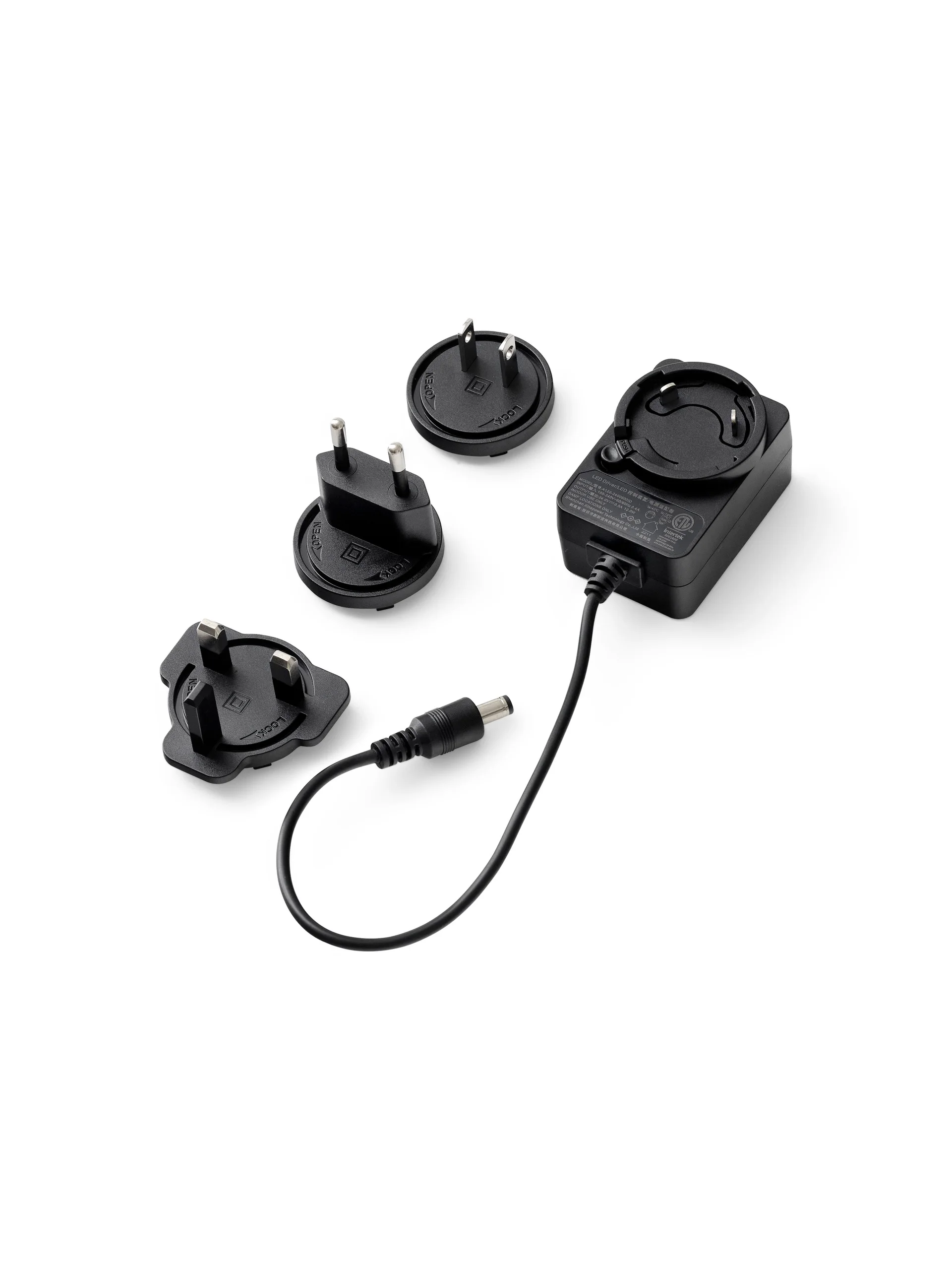 A black Driver Multiplug for Reverse Lamp with three interchangeable international plug heads, on a white background.