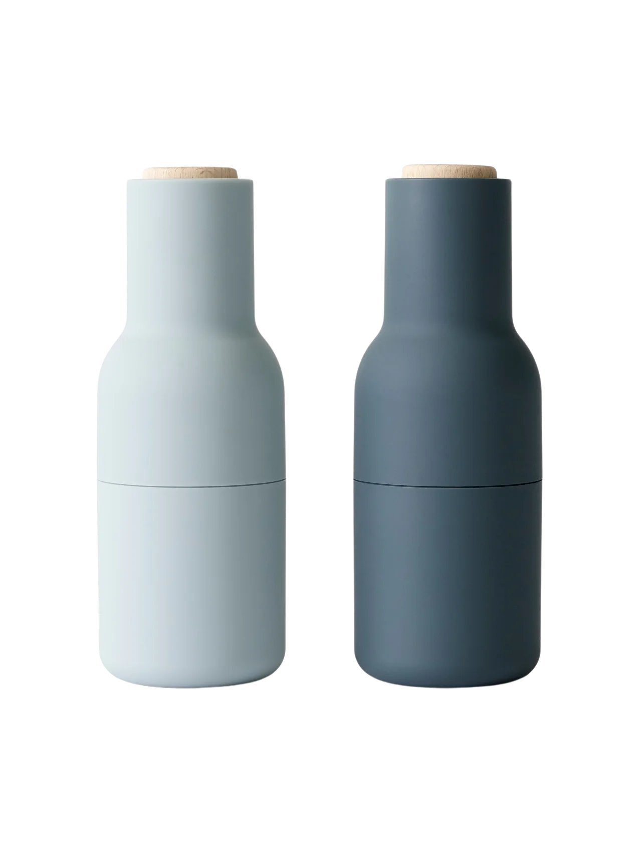 The Bottle Grinder set in light and dark blue. The minimalist, bottle-shaped grinders have matte finishes and wood tops.