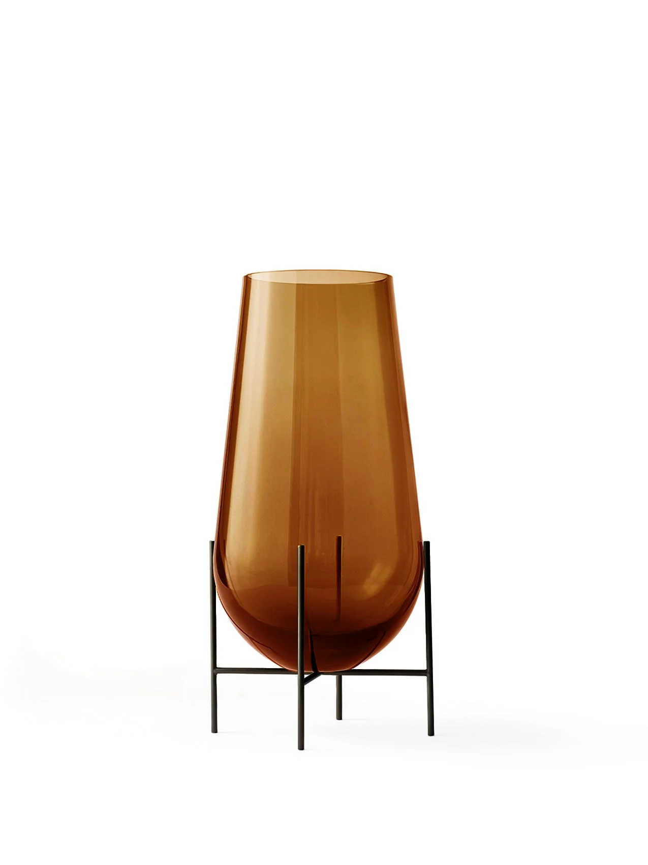 A small Hasse Vase in translucent amber glass, presented in a minimalist bronze-brass stand against a plain white background.
